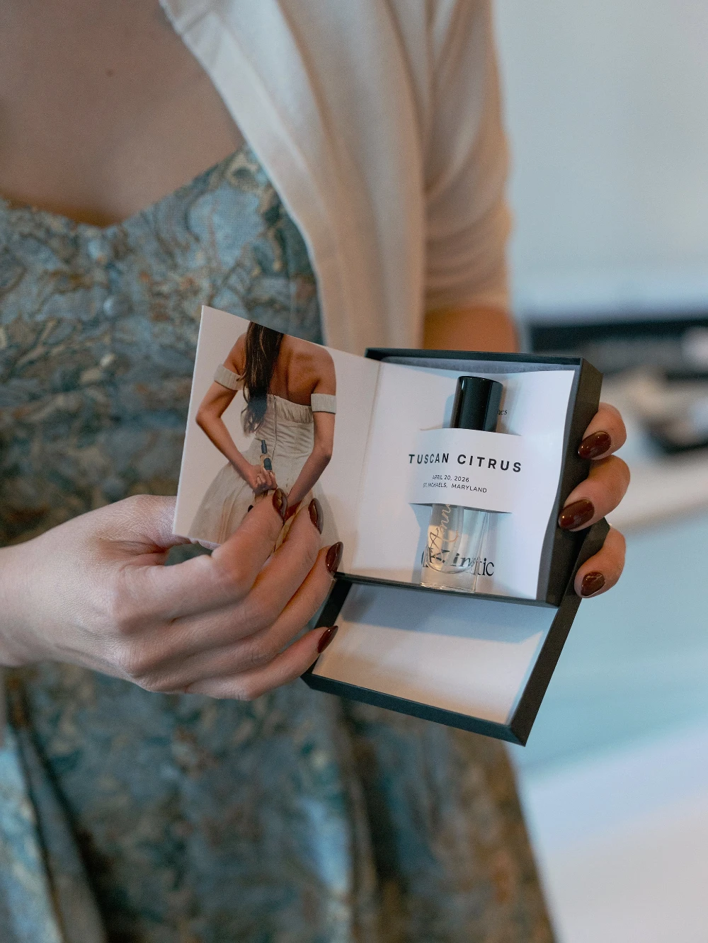 Person holding a perfume box with Tuscan Citrus fragrance by Susan James Fragrances