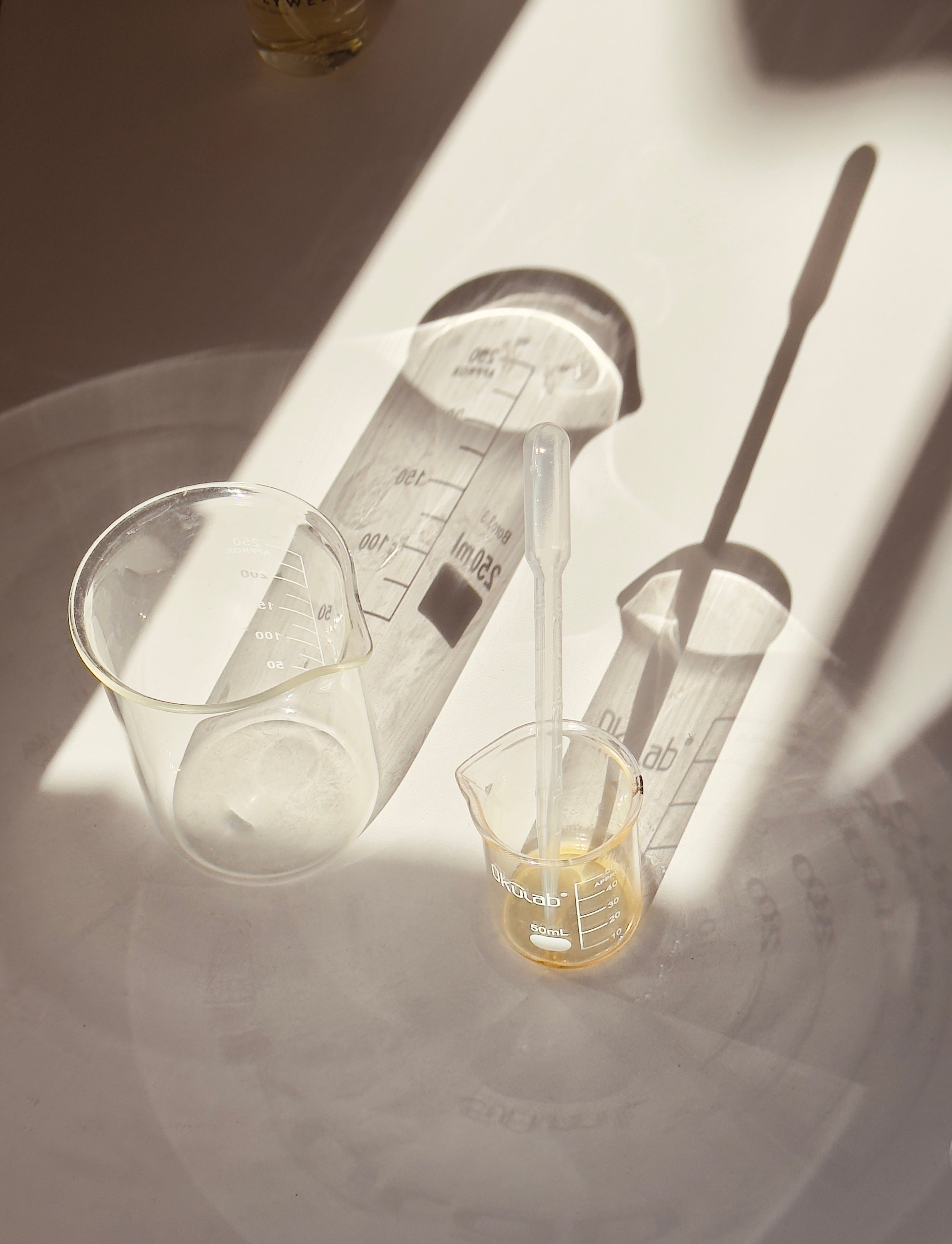 Laboratory measuring cups and beakers on a white surface with a soft focus background