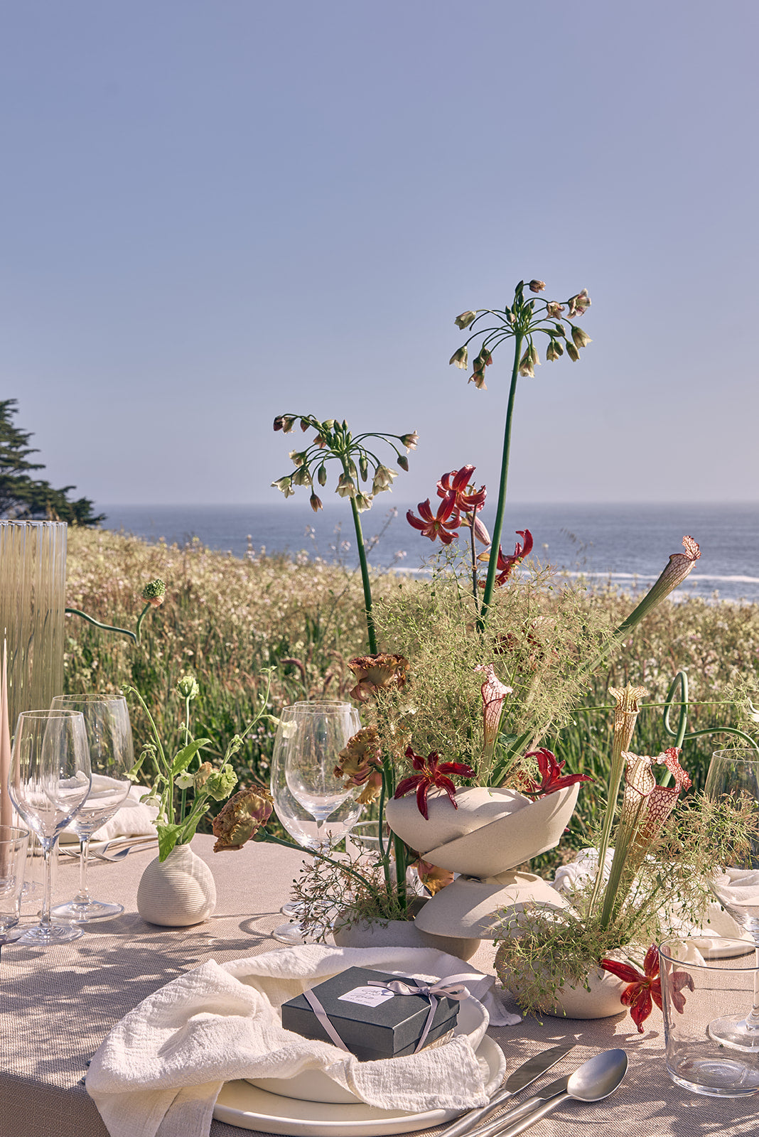 personalized wedding perfume on Table setting with floral centerpiece by the ocean